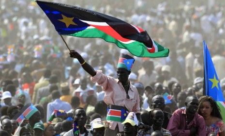 A man waves the South Sudan&amp;#039;s national flag during its Independence Day celebrations Saturday