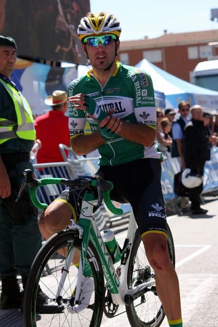 Javier Aramendia (Caja Rural) holds his wrist, hurt by a late crash
