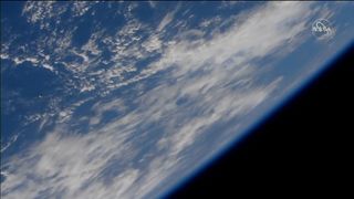 The Russian cargo ship Progress 79 is visible is a small object at the left in this video still from a camera on the International Space Station during its docking approach on Oct. 29, 2021.