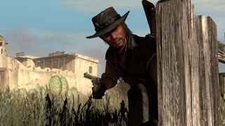 Promotional screenshot of John Marston taking cover in a gunfight in Red Dead Redemption.