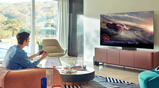 A man playing a video game in a large room on a Samsung TV