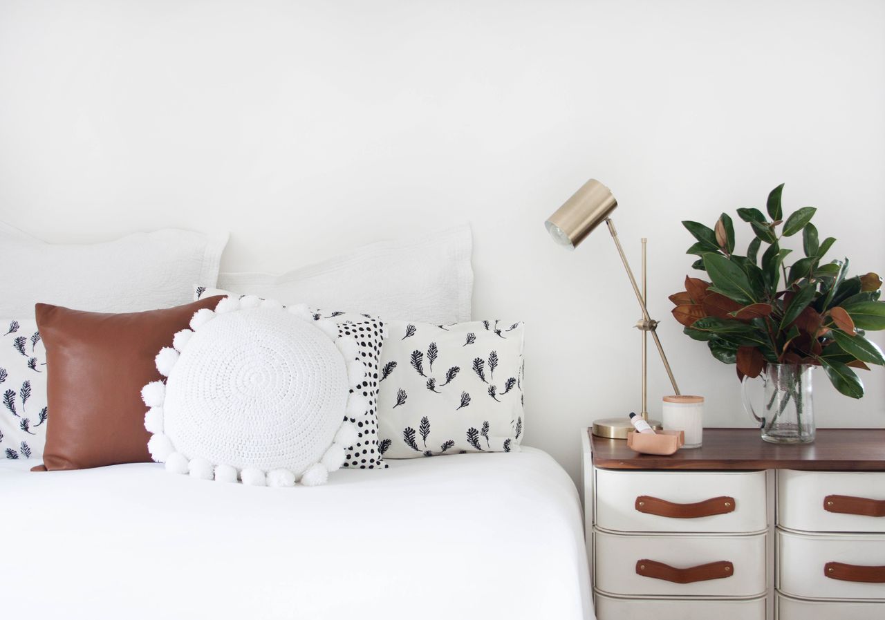 White bedroom with scatter cushions