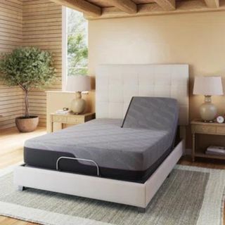 Hartzler Adjustable Bed Frame in a bedroom.