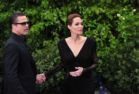 Angelina Jolie and Brad Pitt arrive for the premiere of Maleficent at Kensington Palace