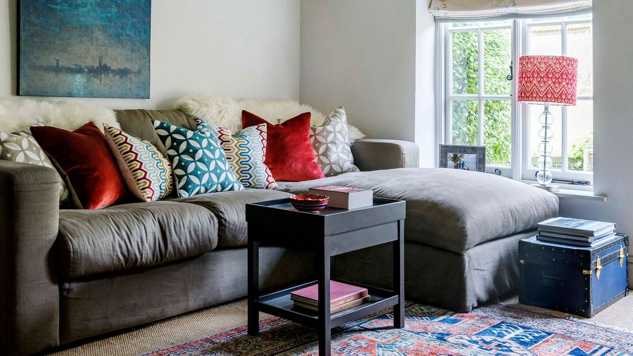 living room with white windows and sofaset with cushions