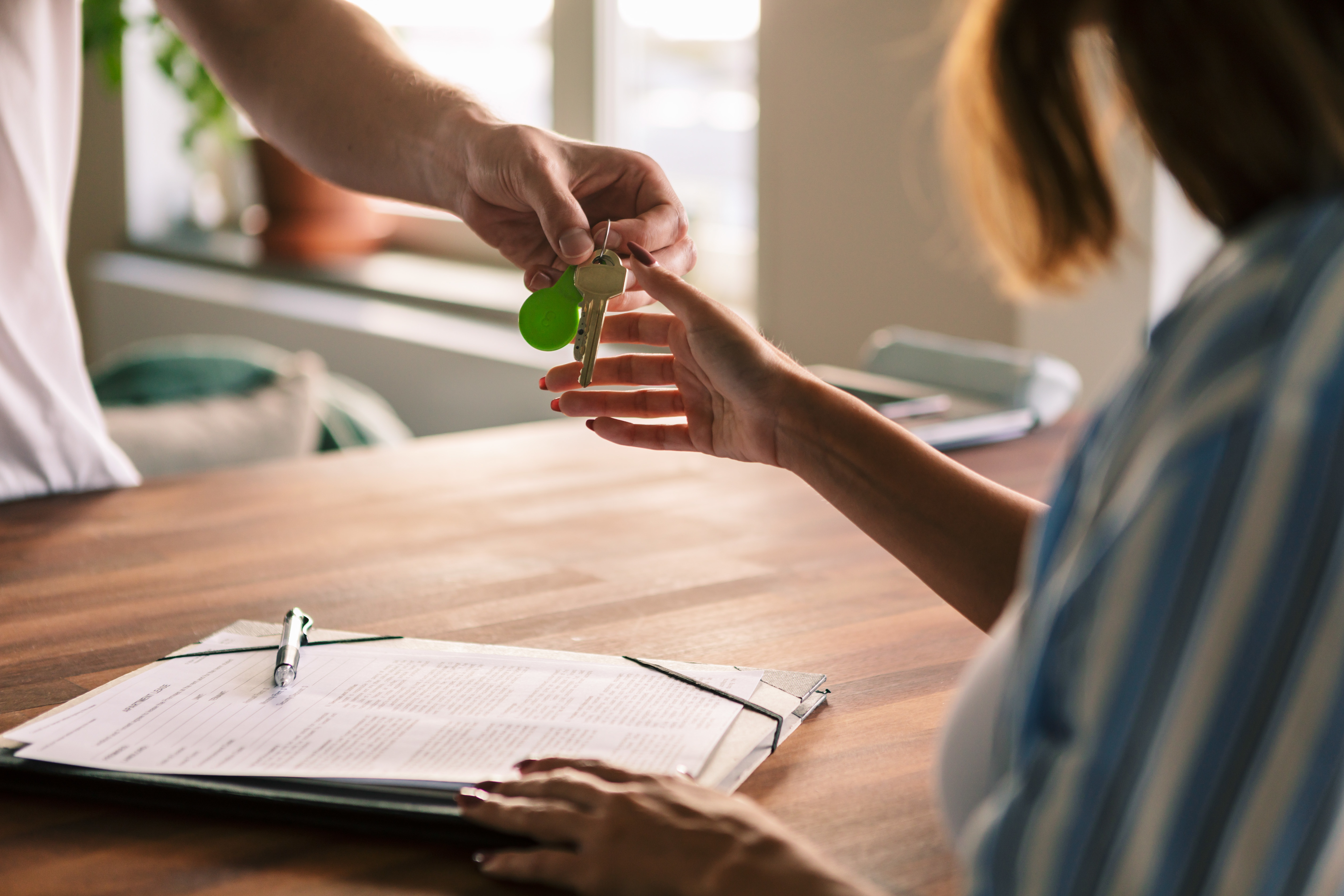 Landlord handing over keys to tenant