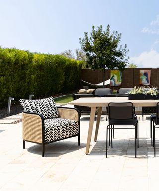 Outdoor dining, table and chairs with monochromatic theme, garden to rear, ground staked lighting,