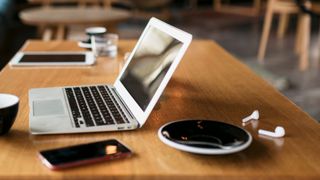 Phone, laptop, and coffee cup on a coffee table