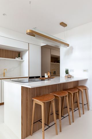 A kitchen peninsula with space for stools