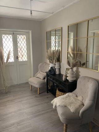 Neutral space with mink colors, upholstered seat and white painted doors