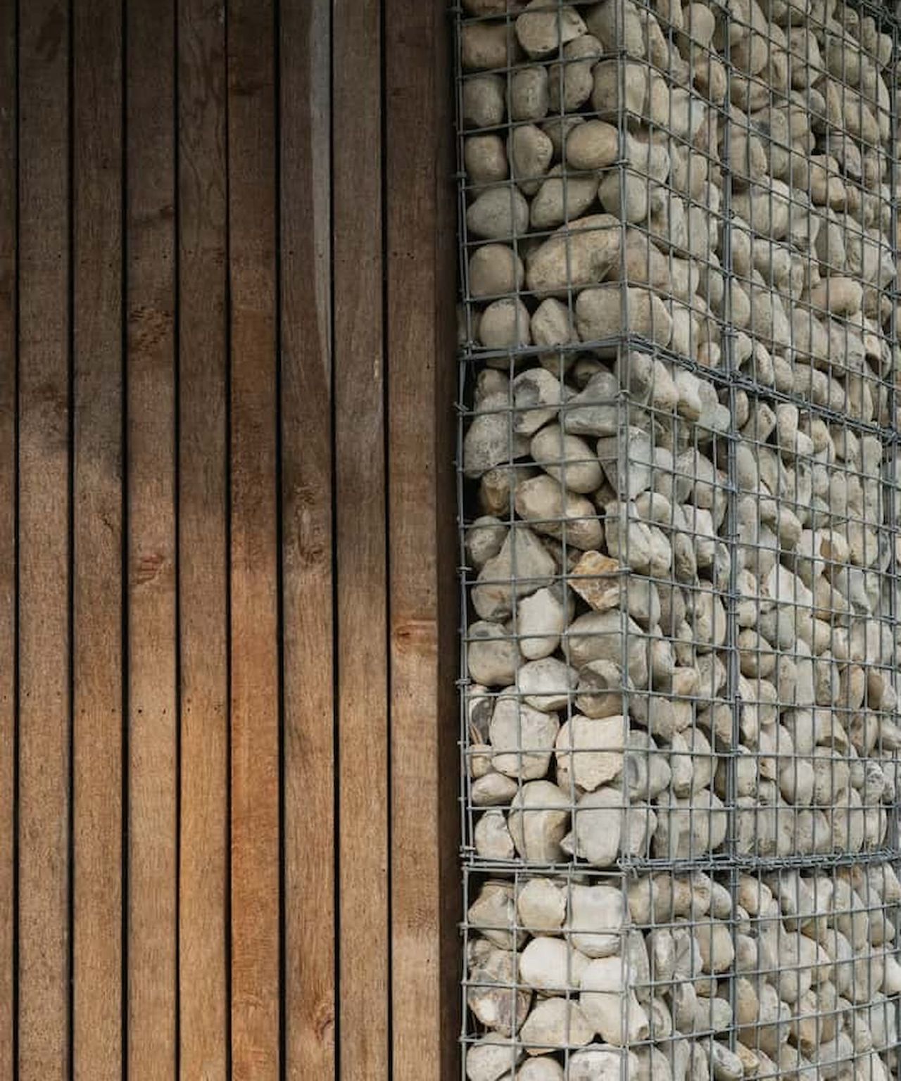 A gabion wall next to timber cladding