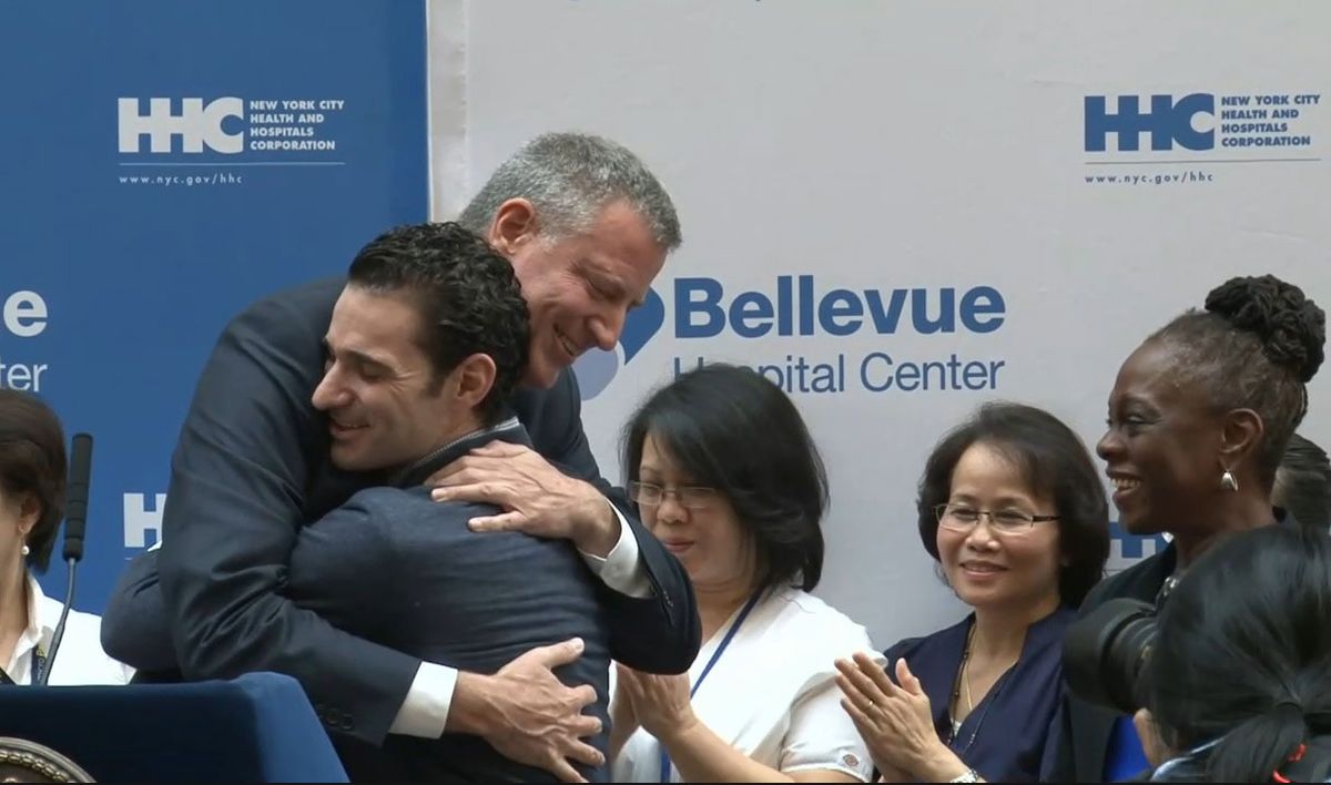 Dr. Craig Spencer hugs New York City Mayor Mayor Bill de Blasio.