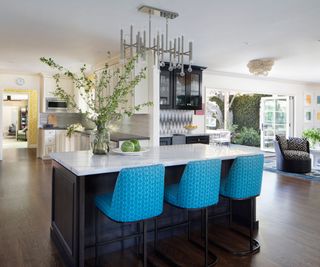 Kitchen island in kitchen with blue bar stools