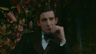 A tuxedoed Josh O'Connor sits in an opera box looking visibly upset in The Crown S4 E9 - "Avalanche."