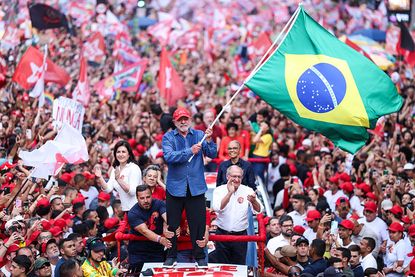 Luiz In&aacute;cio Lula Da Silva waving a Brazil flag &ndash;&nbsp;Brazilian stocks fell after his election victory