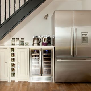 kitchen with wine fridge and staircase