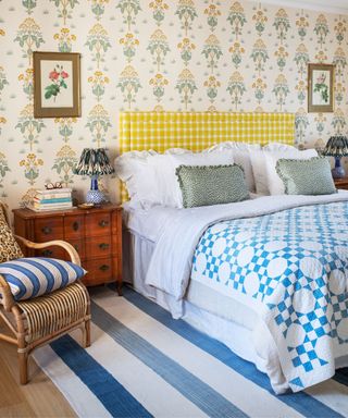 vintage bedroom with yellow floral wallpaper and yellow and blue textiles