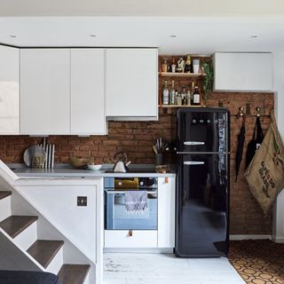 Compact contemporary kitchen with black fridge