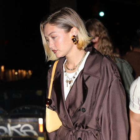 Gigi Hadid wearing a brown coat out with Taylor Swift