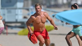 Stephen Amell running in slo-mo on the beach for the 2027 remake of Baywatch on Fox. Yes, he is wearing red shorts.