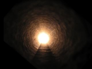 A light at the end of the tunnel, seen during near-death experiences.