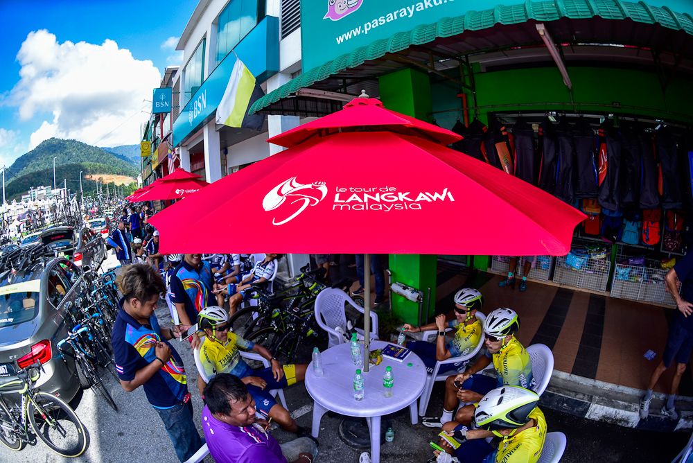 Riders relax at a cafe before a stage start at the Tour de Langkawi