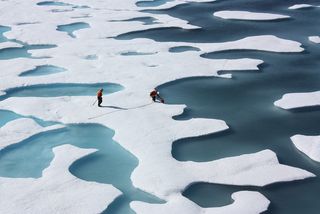Scientists walking on Arctic sea ice.