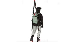Man wearing Arva Airbag Reactor Calgary 18 backpack with skis attached