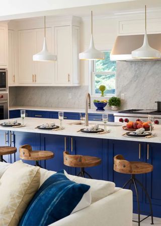 royal blue kitchen with large kitchen island and white wall units