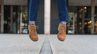 Shoes floating above the ground outside of building