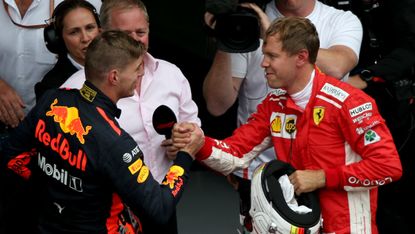 Red Bull driver Max Verstappen shakes hands with Ferrari’s Sebastian Vettel