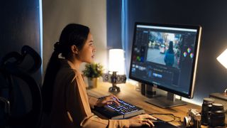 A woman edits her photos on a PC. 
