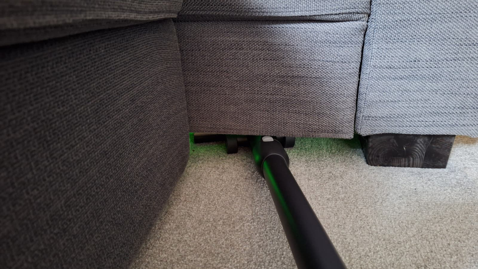 Roborock H60 Hub Ultra cleaning underneath a sofa