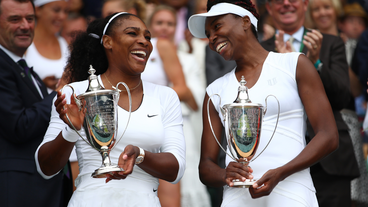 Venus Williams of The United States and Serena Williams of The United States hold their trophies following victory in the Ladies Doubles Final against Timea Babos of Hungary and Yaroslava Shvedova of Kazakhstan on day twelve of the Wimbledon Lawn Tennis Championships at the All England Lawn Tennis and Croquet Club on July 9, 2016 in London, England.