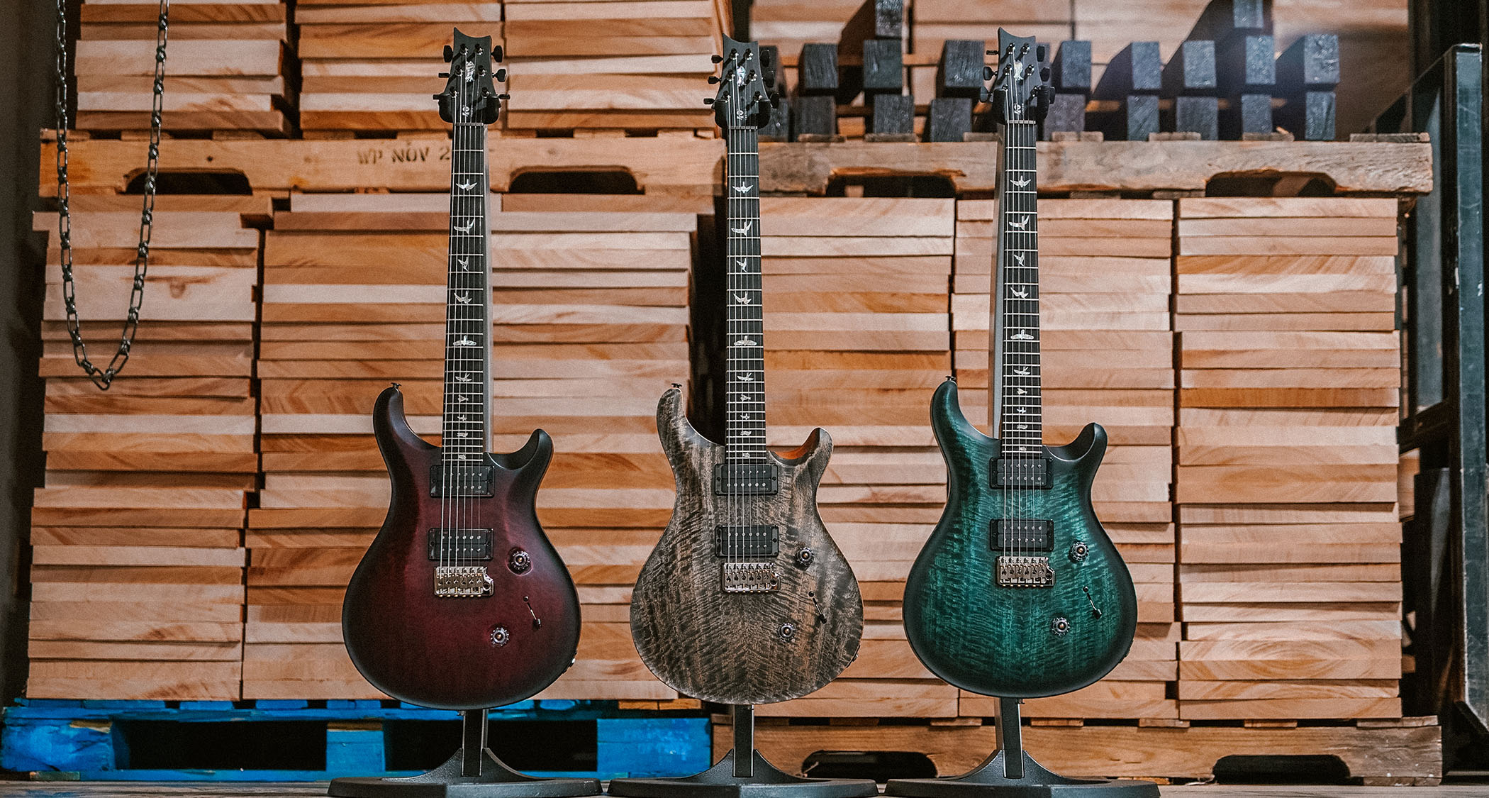 PRS Guitars&#039; new limited edition Custom 24 Satin photographed at the brand&#039;s Maryland factory with wood blanks in the background.