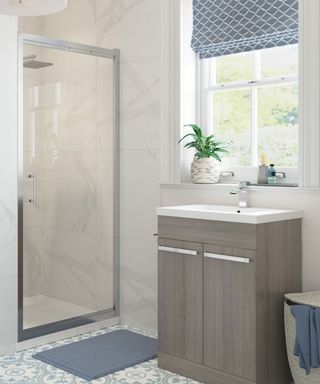 Small bathroom with glass door of shower that folds in to save space