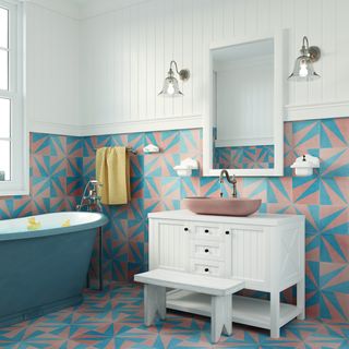 bathroom with blue bath, white vanity and blue and terracotta tiles