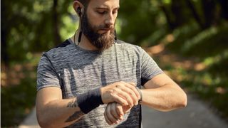 How do step counters work? image shows man looking at fitness tracker