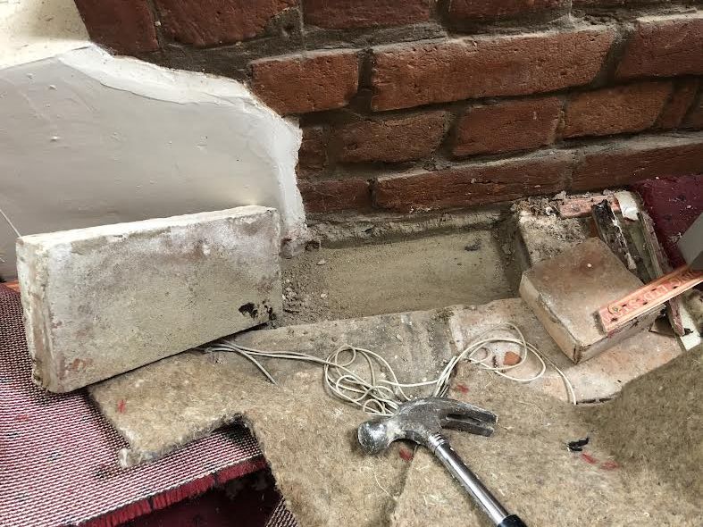 Pulled up carpet in room to expose concrete flooring underneath