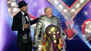 Nick Cannon standing with William Shatner after his elimination on The Masked Singer