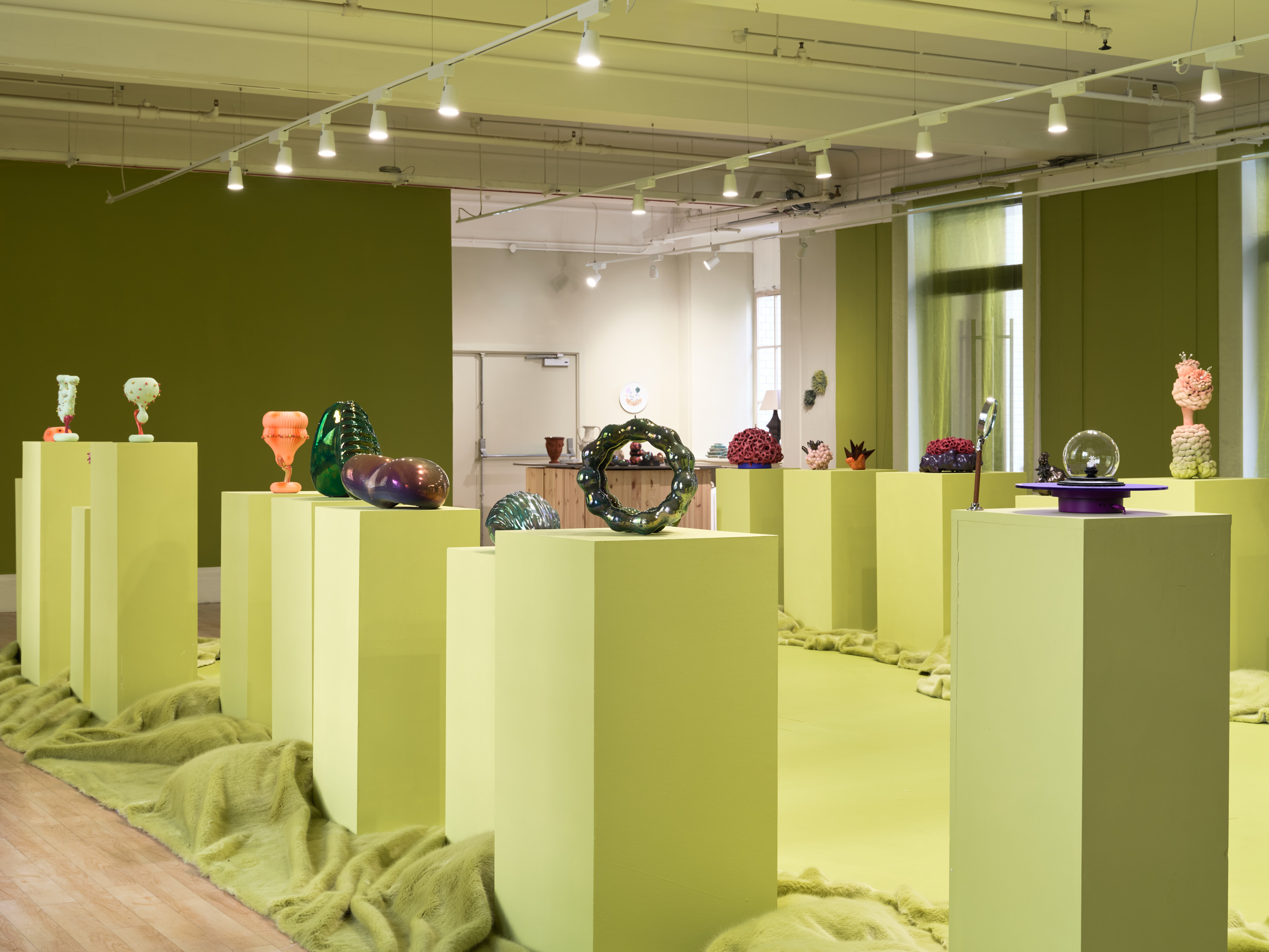 Futuristic ceramics in green gallery space