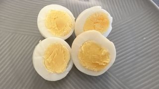 Hard-boiled eggs are air frying on a plate