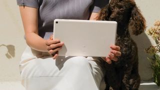 A picture of the Pixel Tablet from the back, in someone's hand