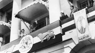 Princess Elizabeth (later Queen Elizabeth II) and Prince Philip, the Duke of Edinburgh, waving from the balcony of City Hall to the crowds below, during their Commonwealth tour, Nairobi, Kenya, 4th February 1952. The tour would be cut short after the death of King George VI during the night of 5th-6th February and Elizabeth's accession to the throne.