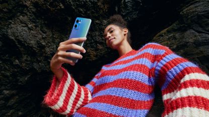 Oppo Find X5 Lite review: woman taking a selfie on a phone