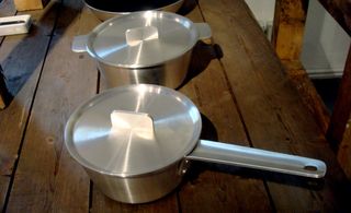 An aluminium steel medium size saucepan and an aluminium steel medium size pot. Both with lids.