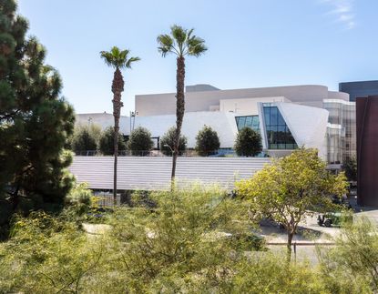 exterior view of Orange County Museum of Art by Morphosis seen through greenery