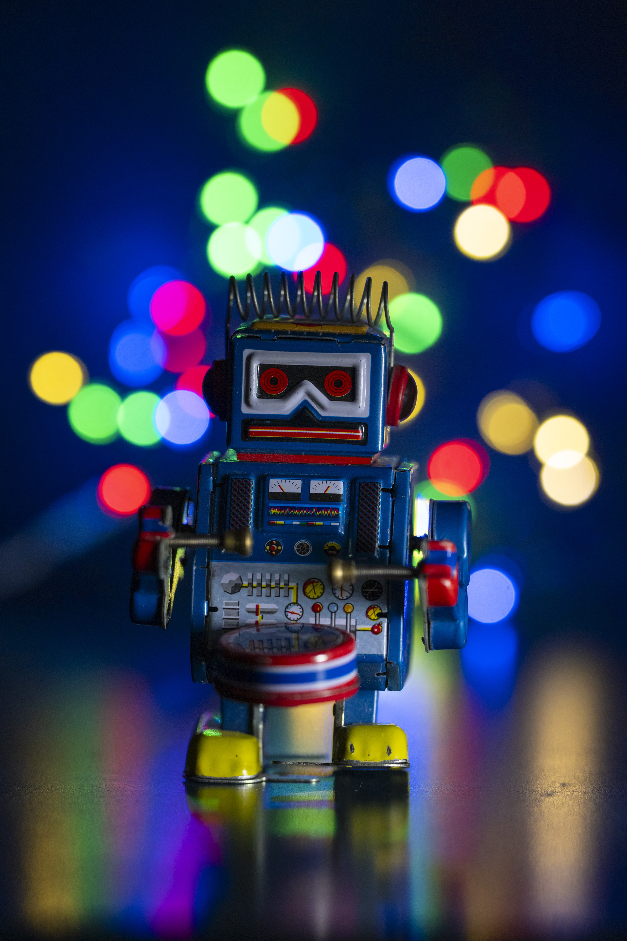A test shot of a toy metal robot with string lights set up behind it to produce bokeh at different apertures