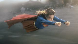 Milly Alcock's Kara Zor-El wearing her classic superhero suit as she flies through the air in 2026's Supergirl movie