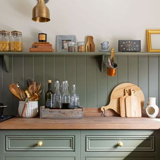 green panelled kitchen with gold hardware